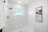 large walk in shower with custom glass insert