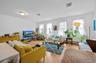 Living room featuring light wood-style floors, crown molding, and baseboard heating