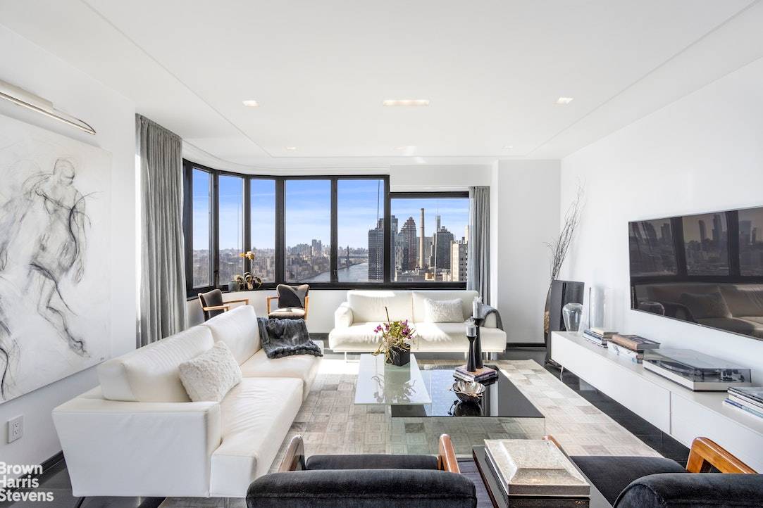 NEW PRICE ! Jaw dropping panoramic views which pour over the East River and New York City skyline frame every room of this pristine, designer full floor residence on Manhattan's ...