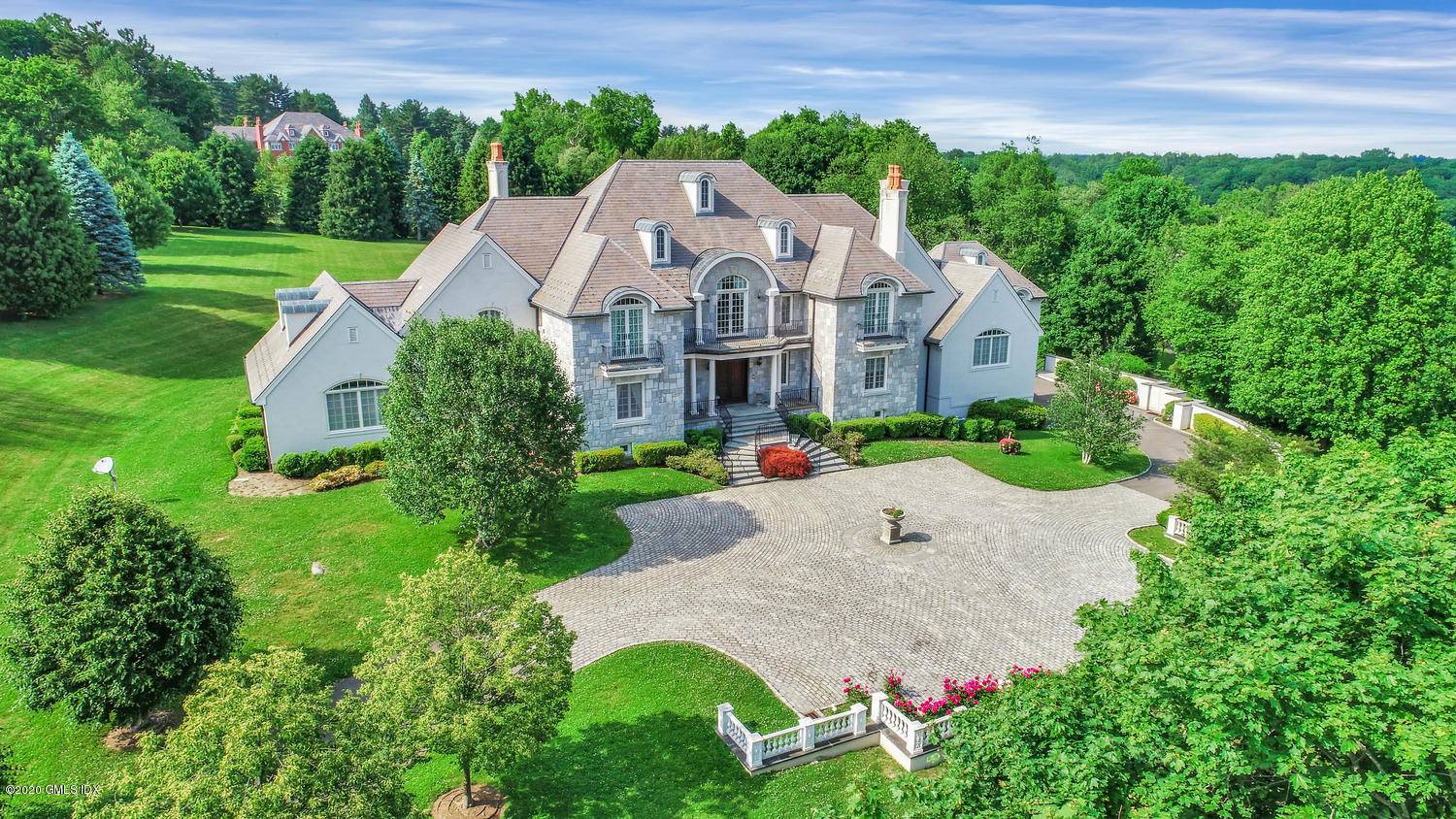 Scenic Round Hill Road leads to this exceptional estate on 4 acres with an additional 7.