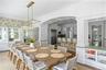 Dining area with arched walkways, a decorative wall, ornate columns, and crown molding