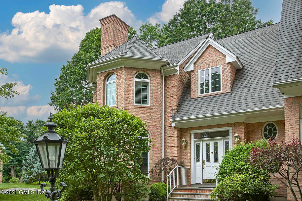 Impeccable brick townhome in the ''Greenwich Terrace'' development, which boasts a lovely park like setting and seasonal water views of LI Sound.
