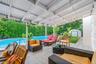 Fenced backyard featuring outdoor lounge area, a patio area, a storage shed, and view of wooded area