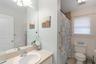 Bathroom featuring light tile patterned flooring, vanity, and a shower with curtain