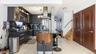 Kitchen featuring decorative light fixtures, modern cabinets, appliances with stainless steel finishes, dark cabinets, and island exhaust hood