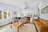 Living area with dark wood finished floors, vaulted ceiling, and recessed lighting