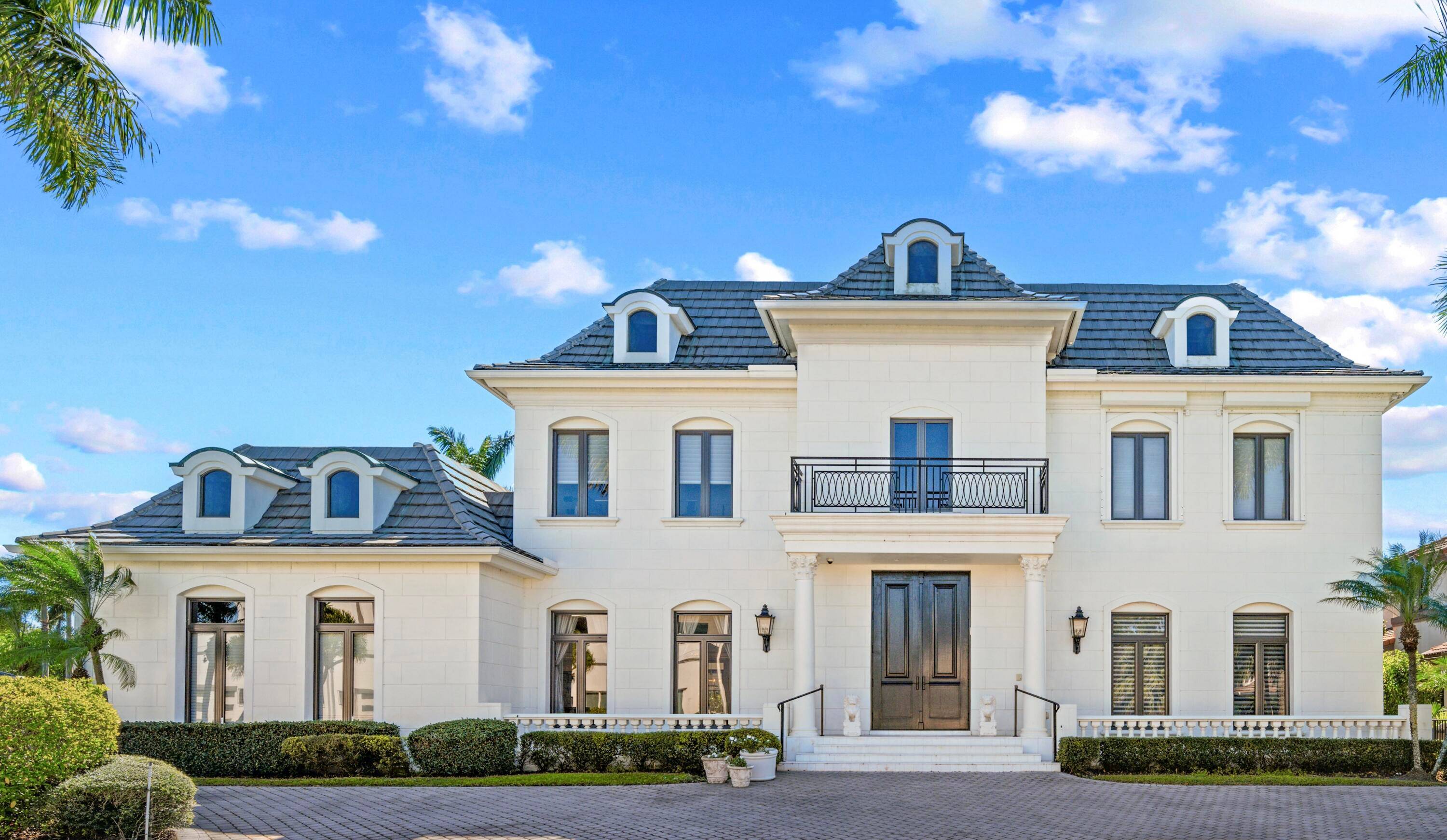 The absolute epitome of luxury living at this exquisite custom home nestled in the heart of Boca Grove Plantation, one of Boca's most exclusive country clubs.