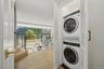 A conveniently located laundry closet off the foyer provides the ease and practicality of in-unit laundry while remaining discreetly tucked away.