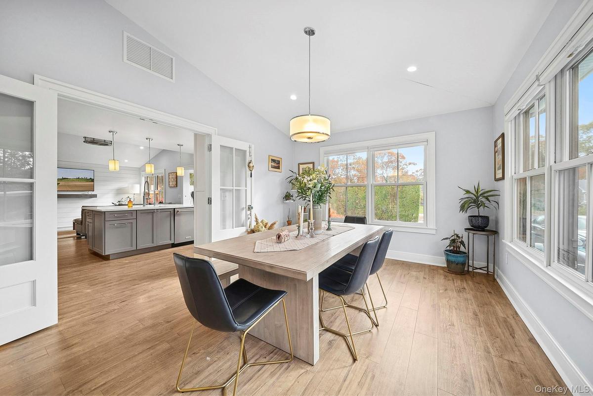 Dining space featuring lofted ceiling, light wood-type flooring, and recessed lighting