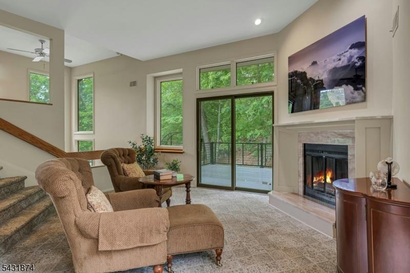 Den with Fireplace and Deck