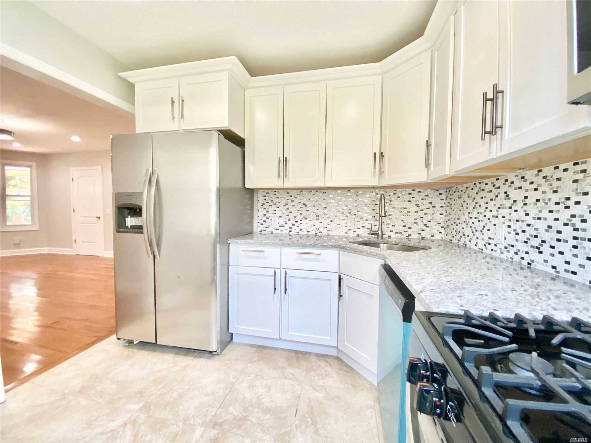 Fully Renovated, new kitchen with new cabinet, new granite countertops all new appliances, new bathrooms,, new floors, doors, roof, new hot water heater, new boiler.