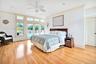 First Floor Primary Bedroom with access to exterior, light wood-style floors, a ceiling fan, ornamental molding, and recessed lighting