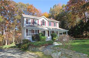 Welcome to this impeccably maintained colonial with inviting mahogany wrap around front porch.