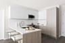Kitchen with appliances with stainless steel finishes, white cabinetry, dark hardwood / wood-style flooring, a kitchen breakfast bar, and kitchen peni