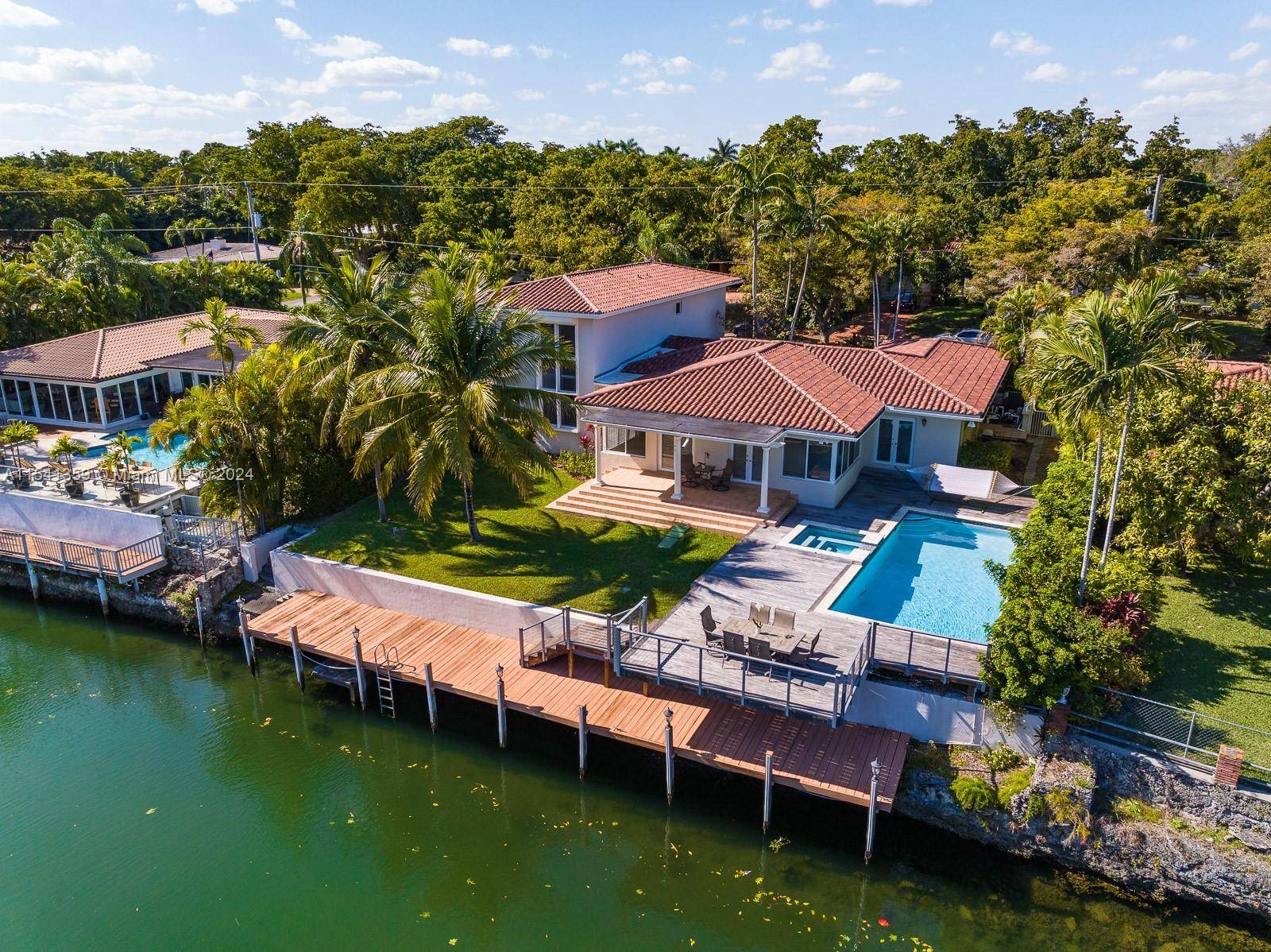Welcome to 616 Jeronimo, a truly graceful waterfront residence nestled on a quiet Coral Gables street.