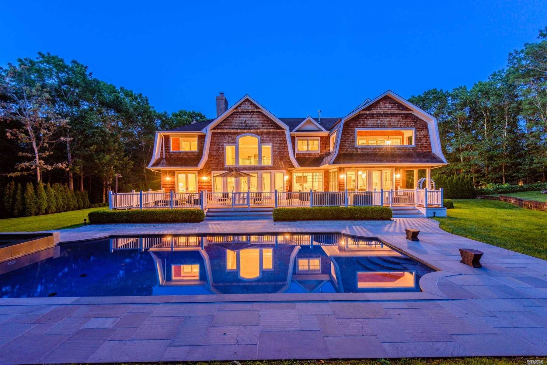 Bordering a 22 acre reserve and located at the end of a cul de sac, this gated Southampton estate is sited on 2.