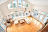 View from Second Floor family room overlooking the Living area featuring wood finished floors, a towering ceiling, and recessed lighting