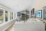 Carpeted living room with vaulted ceiling and baseboards