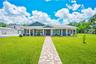 Front View: Metal Tile Shingles, Front Porch with Swing, Paver Walkway to front door and detached garage