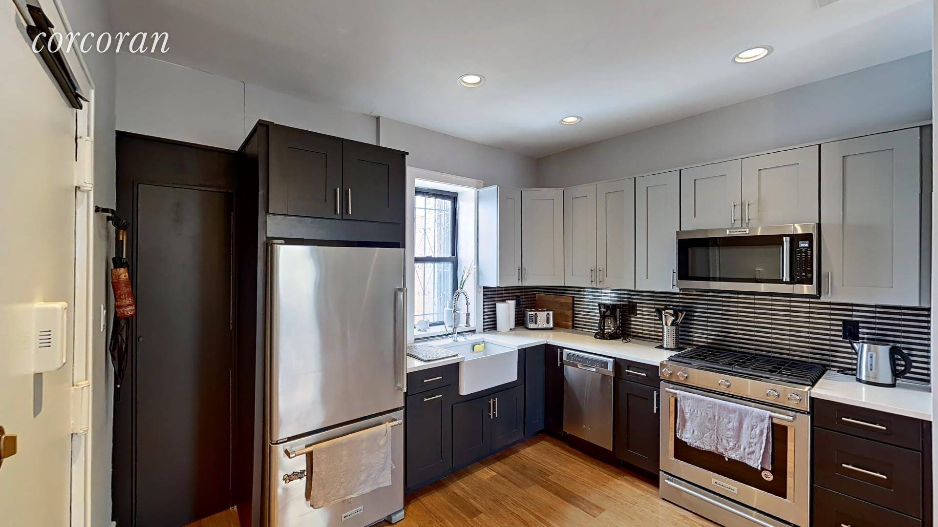 Three large bedrooms, two modern bathrooms, W D in unit, hardwood floors, open kitchen with quartz counters, dishwasher and stainless appliances, tiled backsplash.