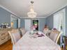 Dining area with a chandelier, wood finished floors, and crown molding