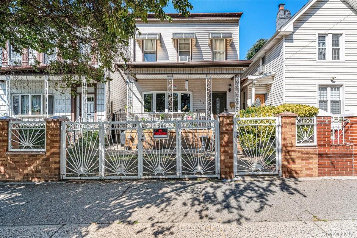 This beautiful multi-level home stands out with its eye-catching white iron gates, classic brick pillars, and a welcoming front porch. Shaded by matur