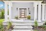 A columned front porch with stone steps, made for rocking chairs and hellos. Neighbors gather at Cavanaugh's on Blue Point Avenue, the local pub for n