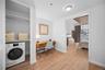 Washroom with washer / clothes dryer, light wood-style floors, and baseboards
