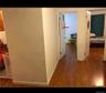 Hallway featuring dark wood finished floors and baseboards