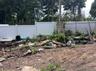 Fenced backyard with a vegetable garden