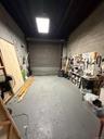 Garage with a workshop area and concrete block wall