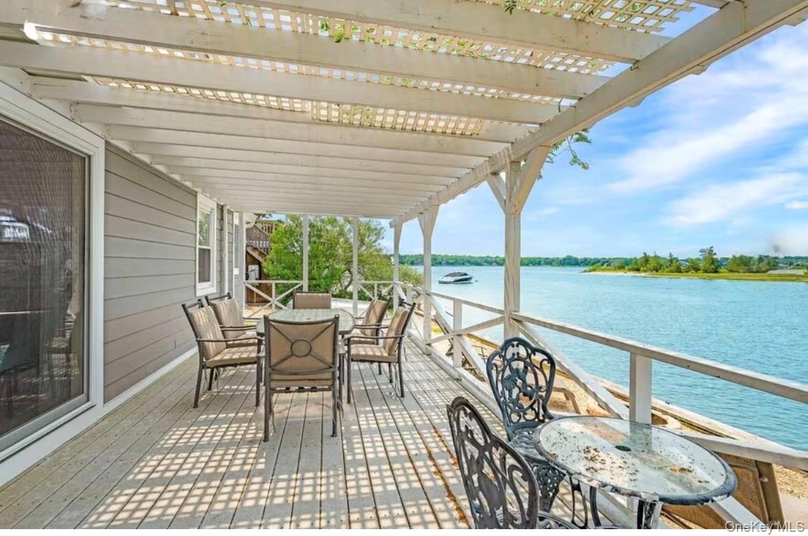 covered seating and dining area overlooking the water.