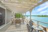 covered seating and dining area overlooking the water.