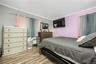 Bedroom featuring ornamental molding and light wood finished floors