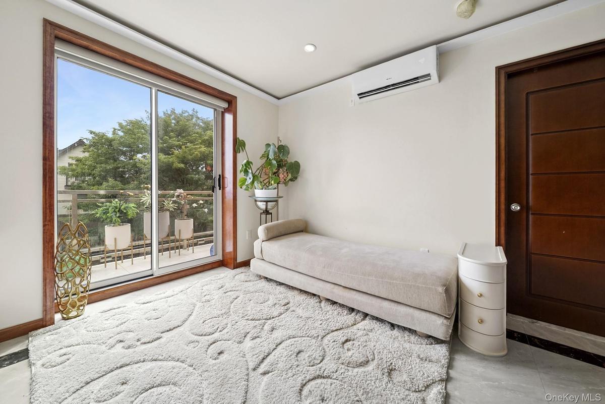 Unfurnished bedroom featuring access to exterior, an AC wall unit, recessed lighting, and tile patterned floors