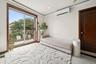 Unfurnished bedroom featuring access to exterior, an AC wall unit, recessed lighting, and tile patterned floors