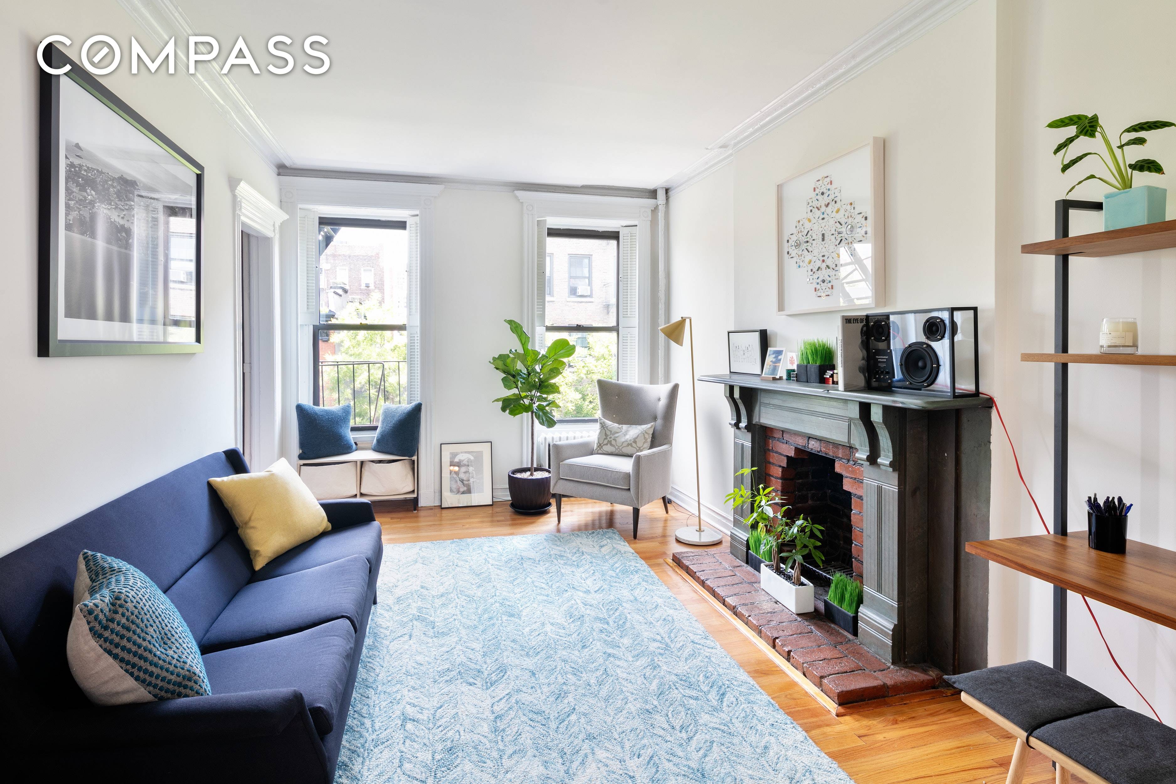 This light filled, charming one bedroom home opens into a bright, north facing living room with 9ft ceilings, crown molding, and a fireplace with a slate mantel.