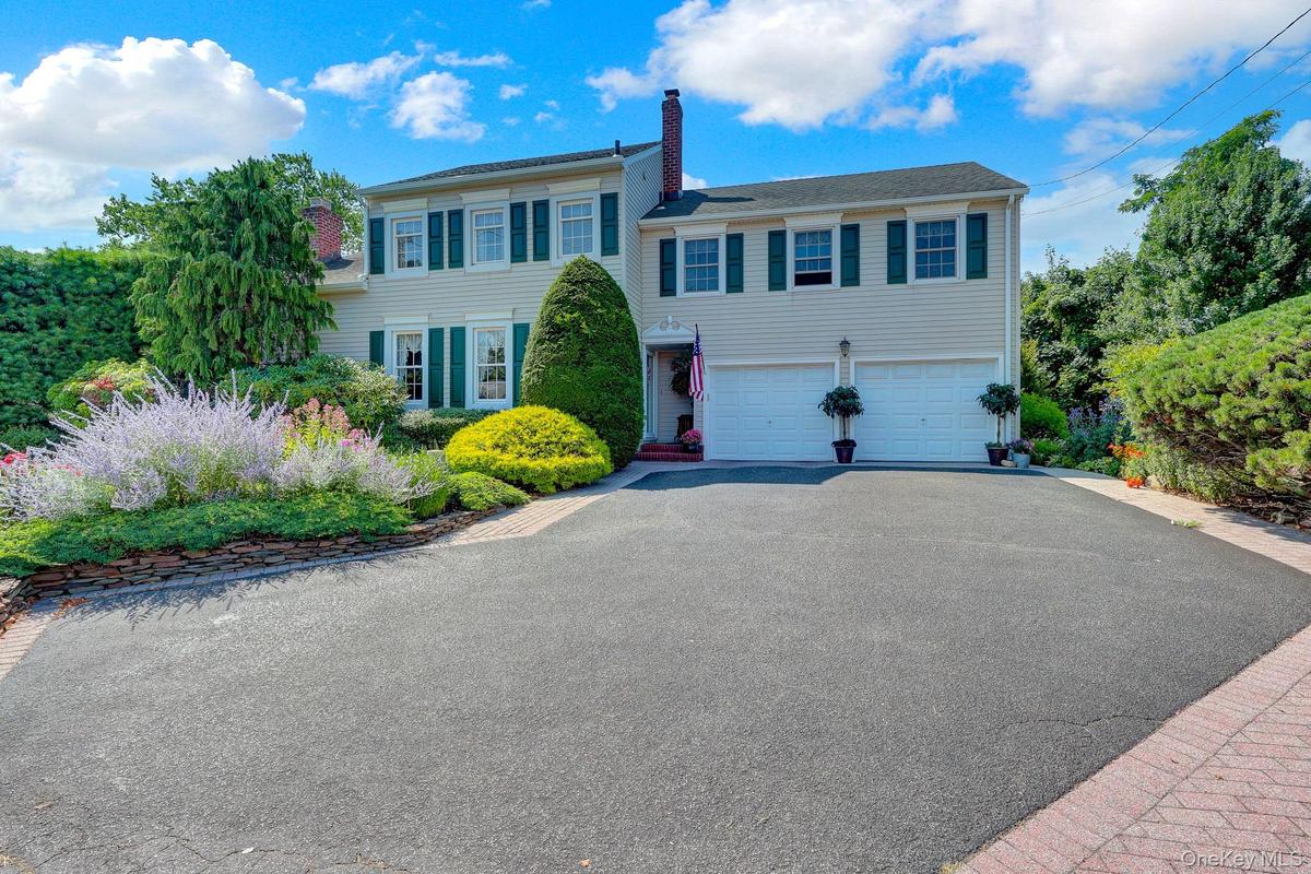 Extra-wide driveway with attached oversized 2 car garage.