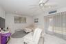 Living area featuring baseboard heating, a ceiling fan, light tile patterned flooring, recessed lighting, and healthy amount of natural light