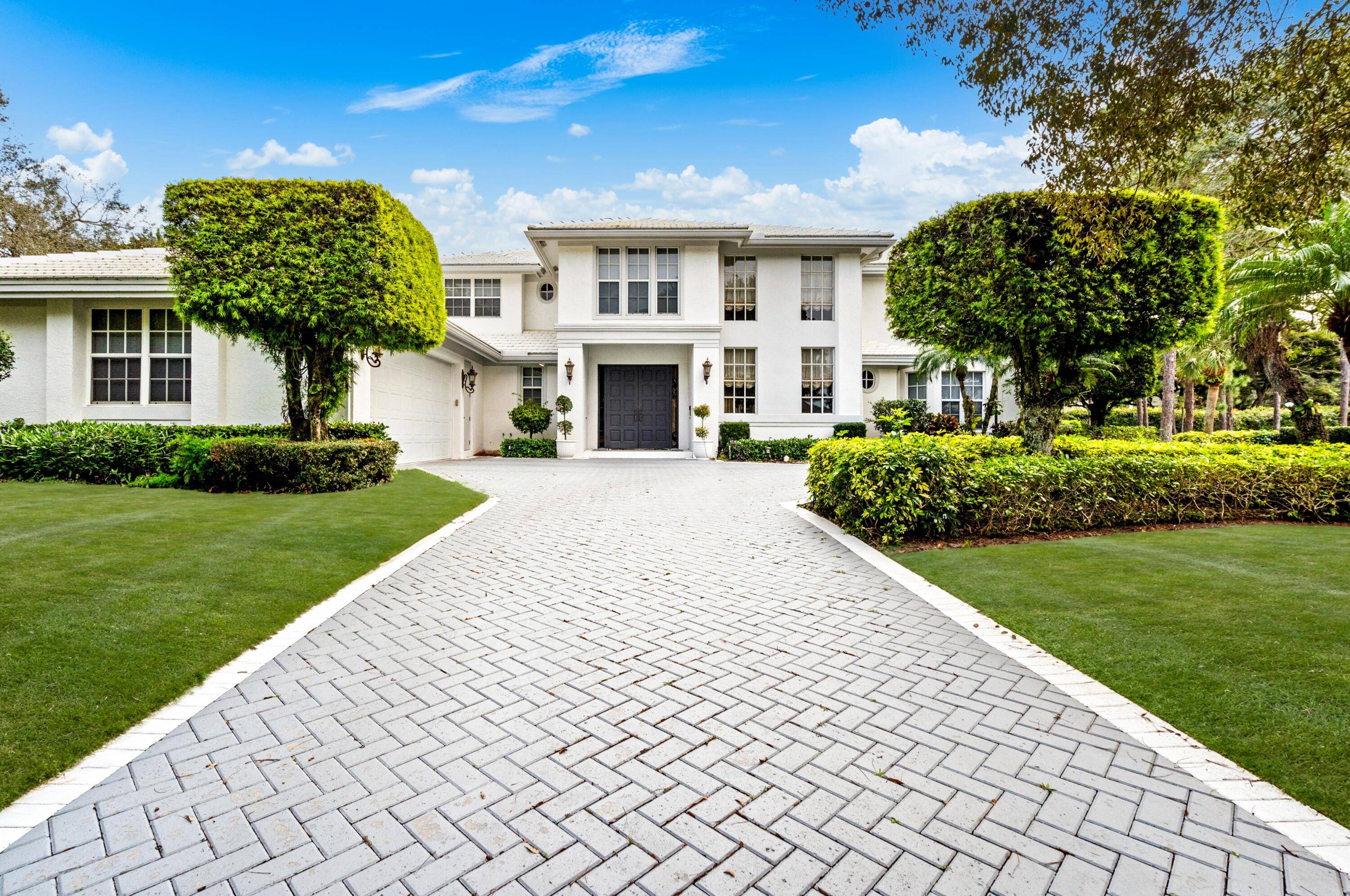Nestled in the exclusive gated enclave of Les Jardins, this gorgeous estate's premier location offers the best of Boca Raton living.