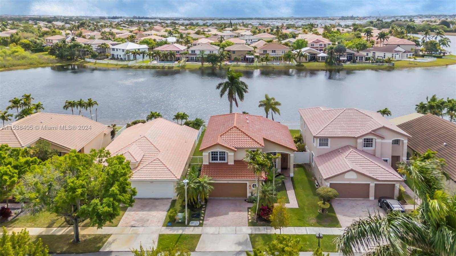 Gorgeous two story home on the lake with a pool, with four bedrooms and three full bathrooms, in the manned guard gated community of Silver Lakes.