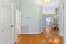 Entryway with coat closet and kitchen in background
