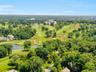 This aerial shot captures the expansive, verdant fairways of the Westchester Country Club, centered by its grand historic clubhouse. 19 PDS is situate