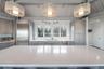 Kitchen featuring gray cabinetry, light countertops, a sink, and appliances with stainless steel finishes