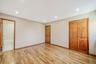 Unfurnished bedroom featuring light wood-type flooring, recessed lighting, a closet, and ensuite bath