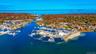 Aerial view of numerous boat docks and a nearby body of water