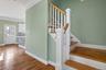 Stairs with ornamental molding and wood finished floors