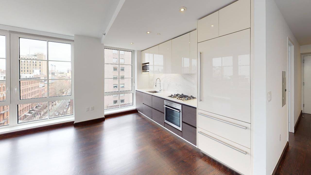 Corner 1 bedroom with over sized windows showcasing open views across 12th Street and 3rd Avenue.