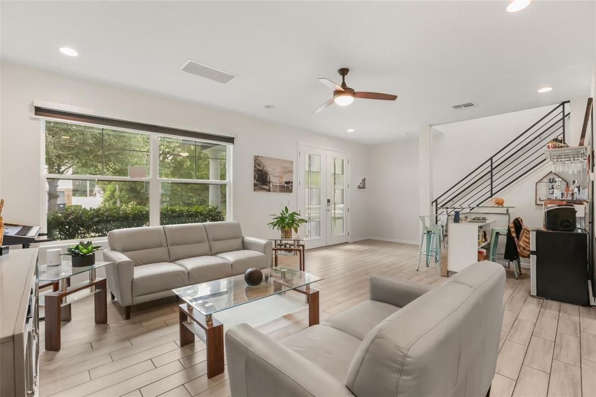 Inviting living room with abundant natural light, high ceilings, and an open layout that creates a bright and welcoming atmosphere.