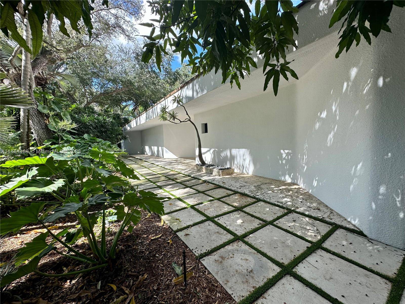 Classic modern masterpiece designed by renowned minimalist architect, Jorge Arango, offers timeless construction, style and quality, located on one of the most coveted private lanes in all of Coconut Grove.